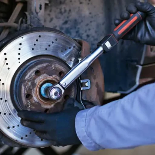 Mechanic working on a vehicle brake rotor